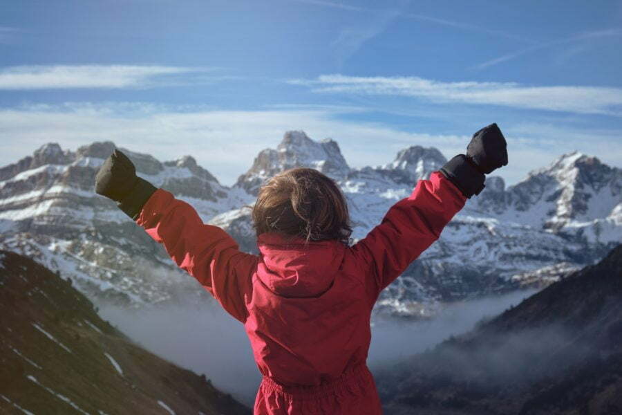 artificial intelligence - anonymous kid celebrating success in mountains - What Actually Leads To Success? | Manifezt Foundation Anonymous kid celebrating success in mountains