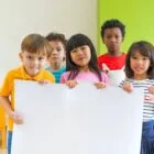 Diversity children holding blank poster in classroom at kindergarten Diversity Equity and Inclusion in STEM Community Development Programs
