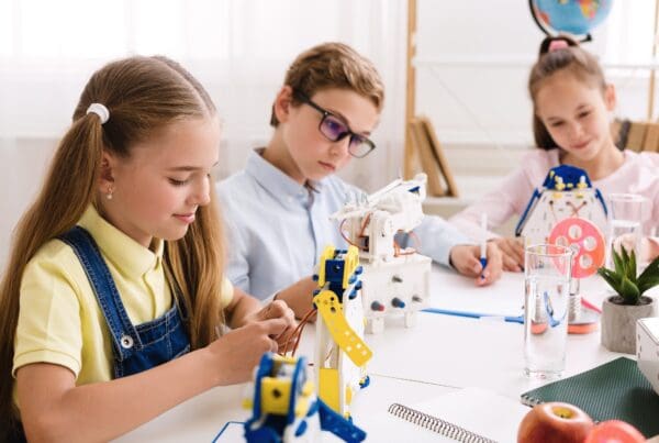 Schoolgirl making diy robot at stem lab Children and Robotics