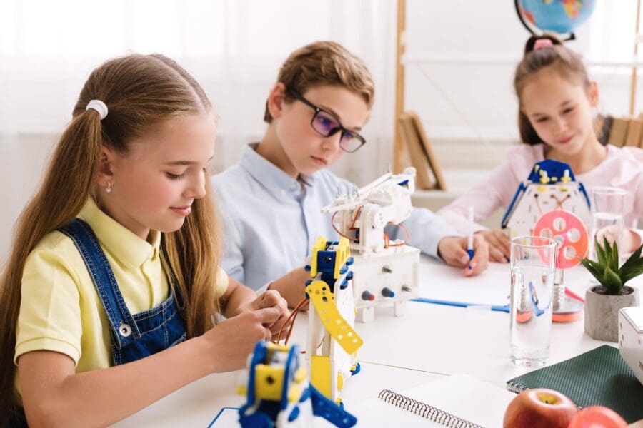 Schoolgirl making diy robot at stem lab Children and Robotics