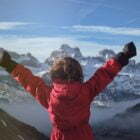 Anonymous kid celebrating success in mountains